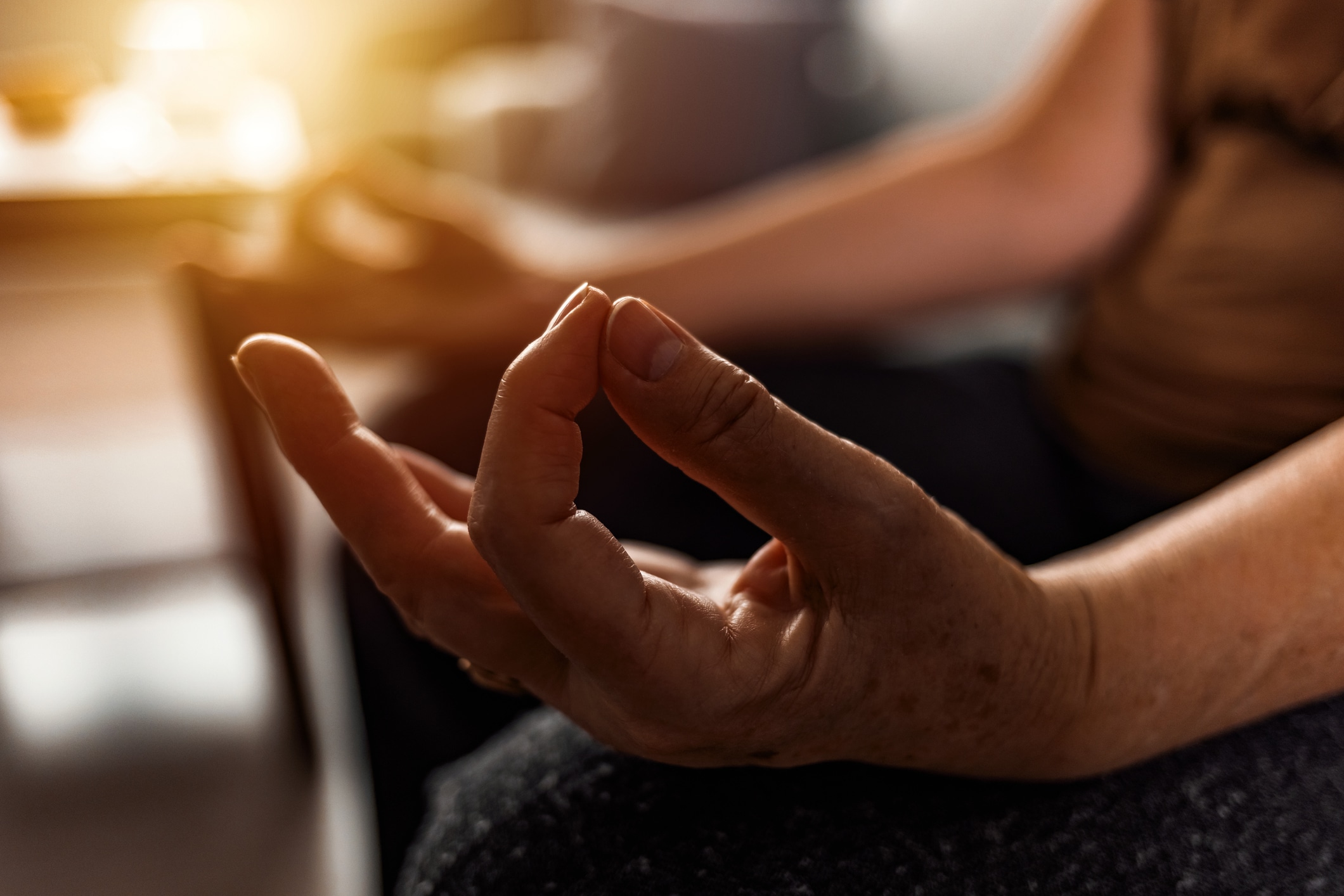 hands practicing meditation and its benefits for stress