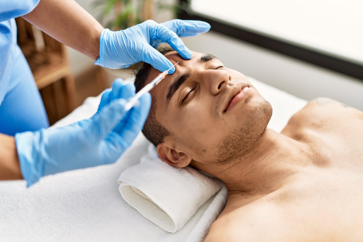 male client obtaining botox in his forehead
